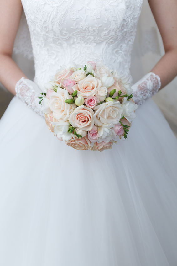 Cream wedding bouquet of roses and freesias